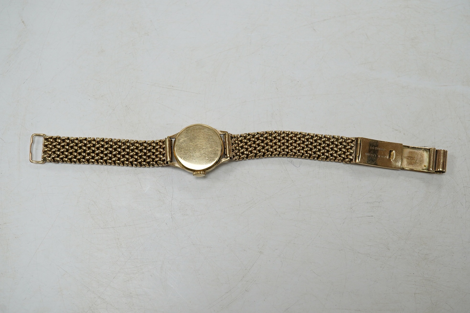 A lady's 9ct gold Omega manual wind wrist watch, on an associated 9ct bracelet, with Arabic and dot numerals, case diameter 20mm, overall length 16.7cm, gross weight 30 grams., no box or papers, with spare bracelet parts